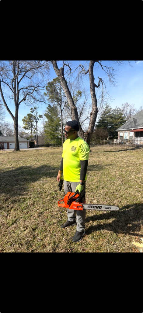 Reggie on the job with chainsaw